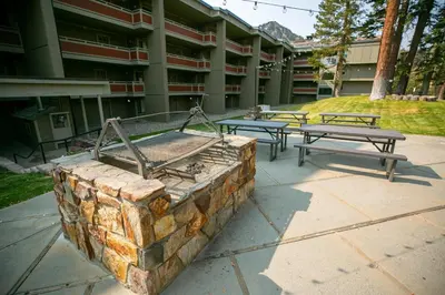a group of picnic tables in front of a building at Retro 3 Bed 3 Bath Condo with Mountain View! in Mammoth Lakes