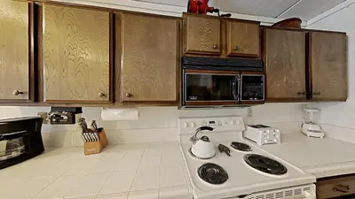 a kitchen with a stove and a microwave at Great 2 Bedroom Condo with Mountain View! in Mammoth Lakes