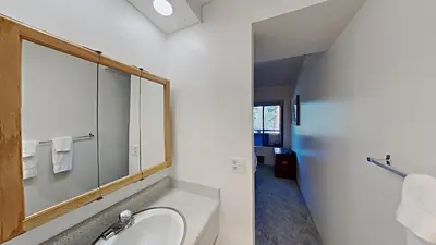 a bathroom with a sink and a mirror at Great 2 Bedroom Condo with Mountain View! in Mammoth Lakes