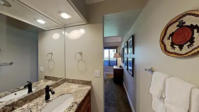 a bathroom with two sinks and a large mirror at 2 Bed 2 Bath Condo Steps Away From Recreation! in Mammoth Lakes