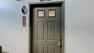 a green door with a sign on a wall at Lakeview 826 Condo #532 Condo in Mammoth Lakes