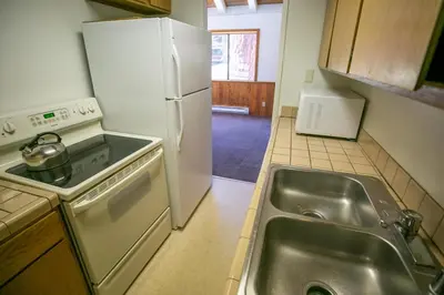 a kitchen with a sink and a white refrigerator at Lakeview 826 Condo #532 Condo in Mammoth Lakes
