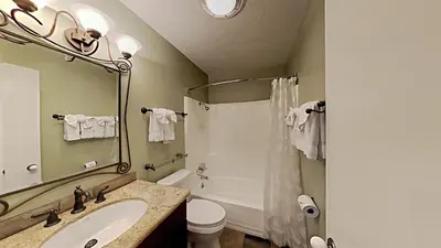 a bathroom with a sink and a shower and a toilet at Beautifully Remodeled 4 Bedroom Condo in Mammoth Lakes