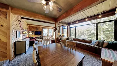 a living room with a wooden table and a couch at Nicely Remodeled 2 Bedroom Condo in Mammoth! in Mammoth Lakes