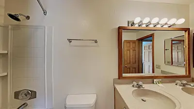 a bathroom with a sink and a mirror at Nicely Remodeled 2 Bedroom Condo in Mammoth! in Mammoth Lakes