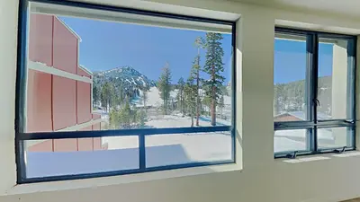 a window in a room with a view of a mountain at Comfortable 2 Bed Condo, Easy Access to Slopes! in Mammoth Lakes