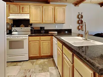 a kitchen with wooden cabinets and a sink at Lakeview 826 Condo #302 Condo in Mammoth Lakes