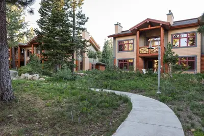 a house with a sidewalk in front of it at Cabins 13 in Old Mammoth