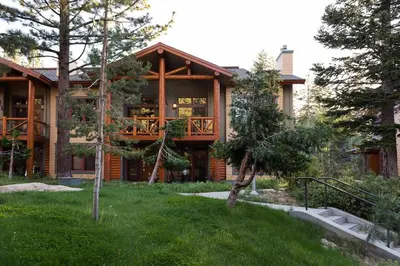 a log home with a porch and a deck at Cabins 21 in Old Mammoth