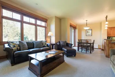 a living room with a couch and a table at Cabins 21 in Old Mammoth