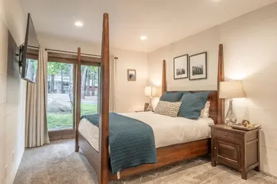a bedroom with a large bed and a window at Canyon Ski and Racquet 16 in Mammoth Lakes