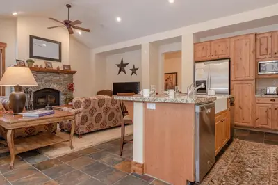 a kitchen and a living room with a fireplace at Lodges 1140- Spacious Townhome on Golf Course in Old Mammoth