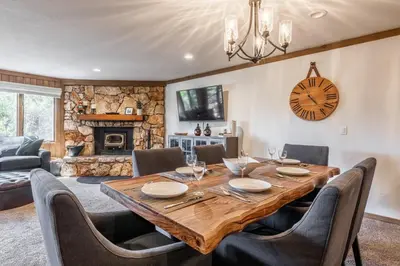 a dining room with a table and chairs and a fireplace at Mountainback 15 in Old Mammoth