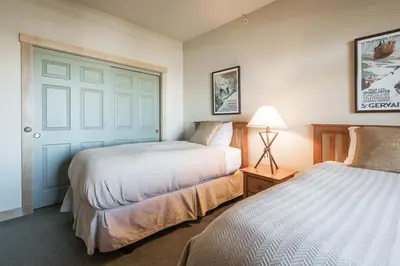 a bedroom with two beds and a blue door at Sunstone 325 in Old Mammoth