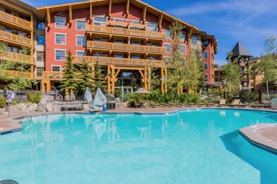 a large swimming pool in front of a hotel at Village 1402 in Mammoth Lakes