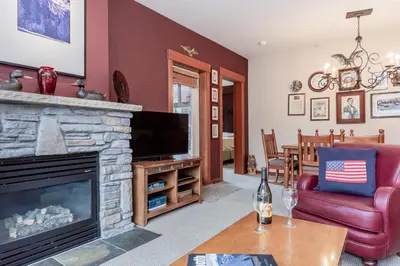 a living room with a television and a fireplace at Village 1402 in Mammoth Lakes