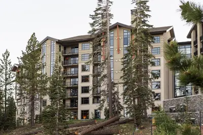 an apartment building with trees in front of it at Village 3311 in Mammoth Lakes