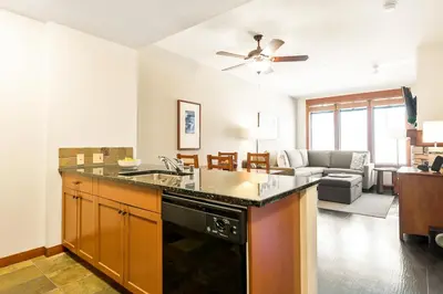 a kitchen and living room with a stove top oven at Village 3311 in Mammoth Lakes