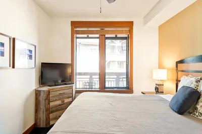a bedroom with a bed and a flat screen tv at Village 3311 in Mammoth Lakes