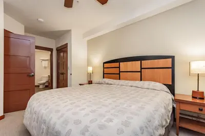 a large bedroom with a large bed and a bathroom at Village 3321 in Mammoth Lakes