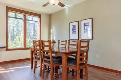 a dining room with a wooden table and chairs at Village 3321 in Mammoth Lakes
