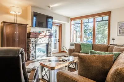 a living room with a couch and a fireplace at Village 3321 in Mammoth Lakes