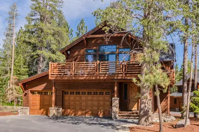a log home with a deck and a garage at Gray Bear 514 in Mammoth Lakes