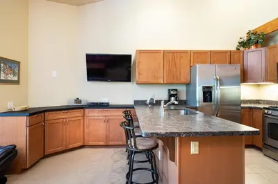 a large kitchen with a sink and a refrigerator at Northstar - Ski Trail Condo in Kingswood Estates
