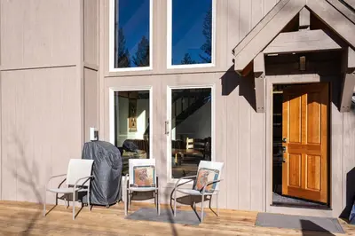 a group of chairs sitting on a patio at North Shore - Cozy Cabin in Wood Vista