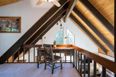 an attic dining room with a wooden table and chairs at North Shore - Cozy Cabin in Wood Vista
