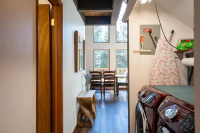 a hallway of a house with a table and chairs at North Shore - Cozy Cabin in Wood Vista