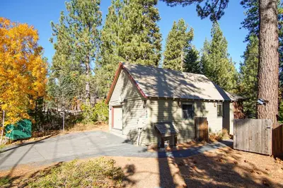an old shed in the woods with a driveway at North Shore - Dancing Antler in Wood Vista