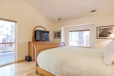 a bedroom with a bed and a flat screen tv at North Shore - Golden Pine in Kings Beach