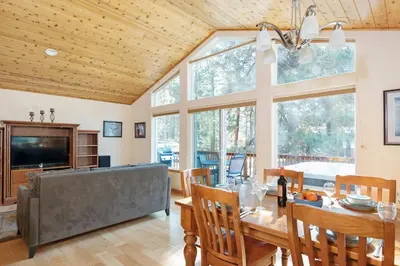 a dining room with a table and a large window at North Shore - Golden Pine in Kings Beach