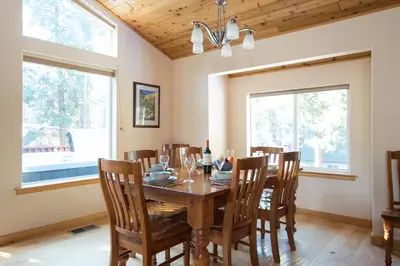 a dining room with a wooden table and chairs at North Shore - Golden Pine in Kings Beach