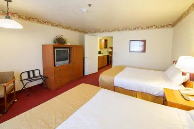 a hotel room with two beds and a television at Murphys Suites in Murphys