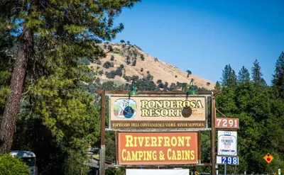 a sign for a resort in front of a mountain at Ponderosa Camping Resort One-Bedroom Cabin 4 in Lotus