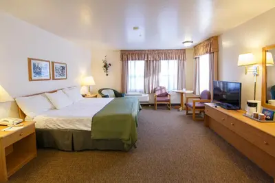 a hotel room with a bed and a television at Murphys Inn Motel in Murphys