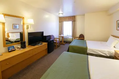 a hotel room with two beds and a television at Murphys Inn Motel in Murphys