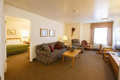 a hotel room with a couch and a bed at Murphys Inn Motel in Murphys