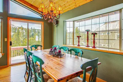 a dining room with a wooden table and chairs at Hillside View Home in Truckee