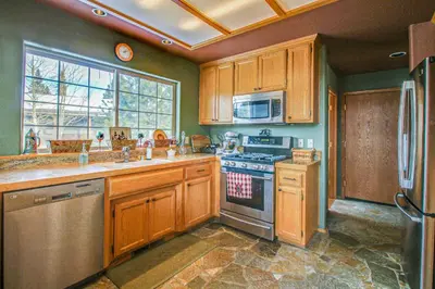 a kitchen with wooden cabinets and a stove top oven at Hillside View Home in Truckee