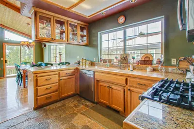 a large kitchen with wooden cabinets and a stove at Hillside View Home in Truckee