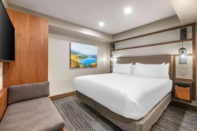 a hotel room with a bed and a chair at Hilton Vacation Club Tahoe Seasons Lake Tahoe in South Lake Tahoe