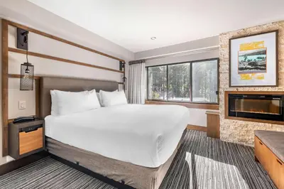 a bedroom with a large bed and a fireplace at Hilton Vacation Club Tahoe Seasons Lake Tahoe in South Lake Tahoe