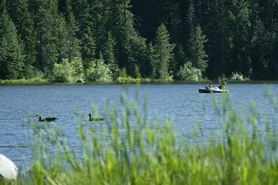 a group of people in a boat on a lake at Snowflower Camping Resort 12 ft. Yurt 9 in Emigrant Gap