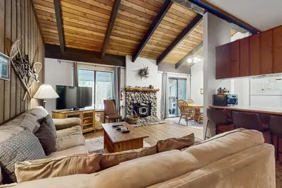 a living room with a couch and a table at Sunshine Sanctuary in Mammoth Lakes
