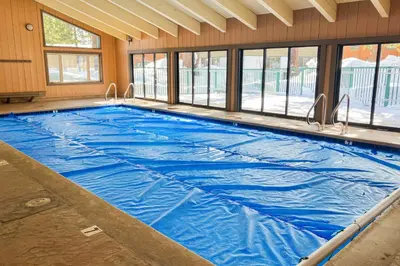 a large swimming pool with blue water in a building at Chateau Sans Nom 31 in Mammoth Lakes