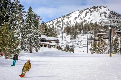 two people standing in the snow on a ski slope at Eagle Run 107 in Mammoth Lakes