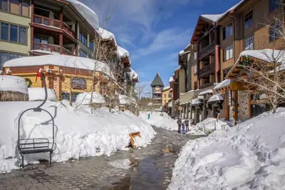 a street covered in snow next to buildings at The Lodges 1145 in Mammoth Lakes